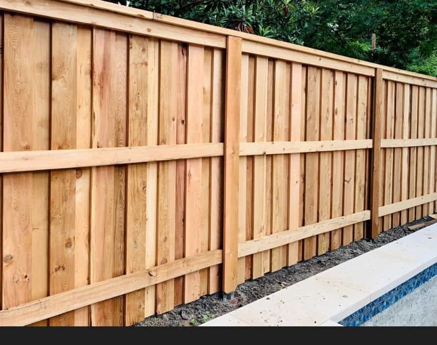 Wooden fence beside a pool area